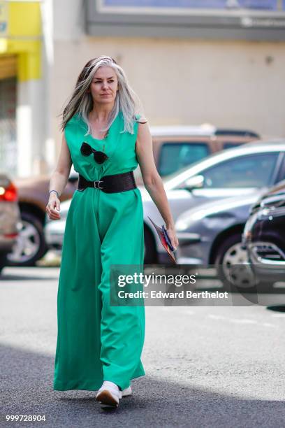 Guest wears a green dress, a large black belt, outside Wooyoungmi, during Paris Fashion Week - Menswear Spring-Summer 2019, on June 23, 2018 in...