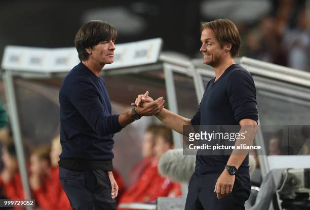 Germany's head coach Joachim Loew and assistant coach Thomas Schneider celebrate the goal for a 1:0 lead for their side during the soccer World Cup...