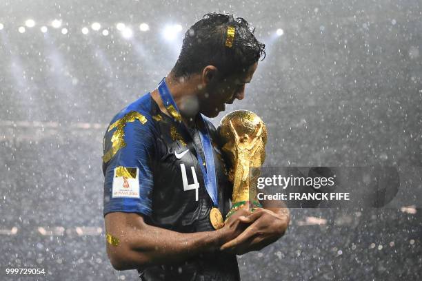 France's defender Raphael Varane holds the World Cup trophy after winning the Russia 2018 World Cup final football match between France and Croatia...