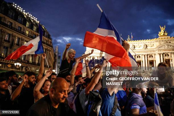 People celebrate France's victory in the Russia 2018 World Cup final football match between France and Croatia, on Place de l'Opera in Paris on July...