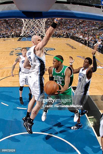 Rajon Rondo of the Boston Celtics passes against Marcin Gortat of the Orlando Magic in Game Two of the Eastern Conference Finals during the 2010 NBA...