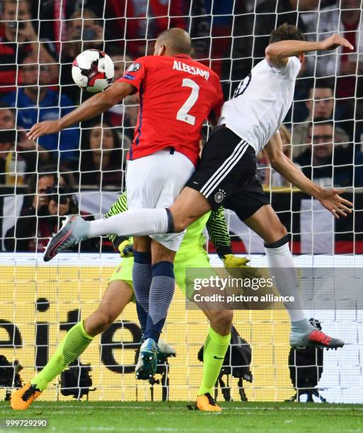 Germany's Leon Goretzka heads the ball to a 5-0 scorem, while Norway's Haitam Aleesami and goalkeeper Rune Jarstein struggle to save the ball during...