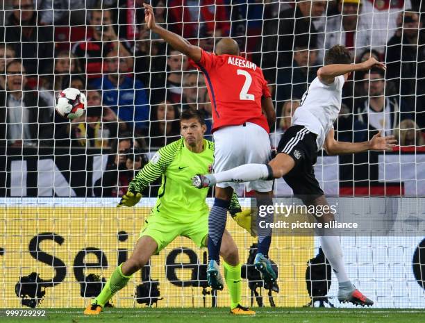 Germany's Leon Goretzka heads the ball to a 5-0 scorem, while Norway's Haitam Aleesami and goalkeeper Rune Jarstein struggle to save the ball during...