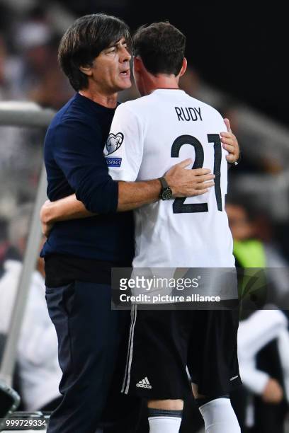 Germany's head coach Joachim Loew hugs Sebastian Rudy during the soccer World Cup qualification group stage match between Germany and Norway in the...