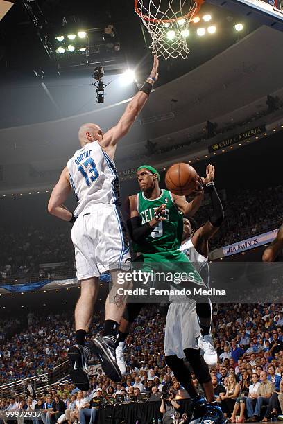 Rajon Rondo of the Boston Celtics passes against Marcin Gortat of the Orlando Magic in Game Two of the Eastern Conference Finals during the 2010 NBA...