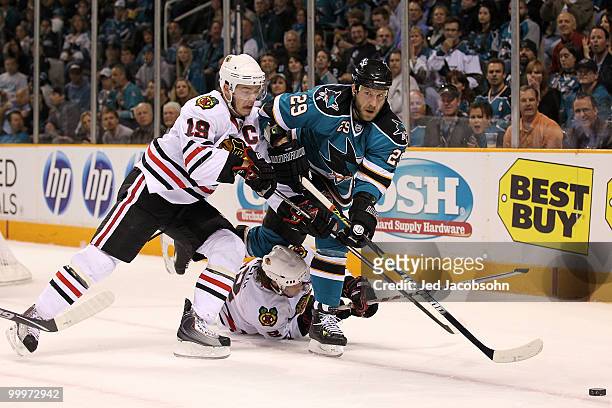 Ryane Clowe of the San Jose Sharks goes after the puck alongside Jonathan Toews of the Chicago Blackhawks in the first period of Game Two of the...
