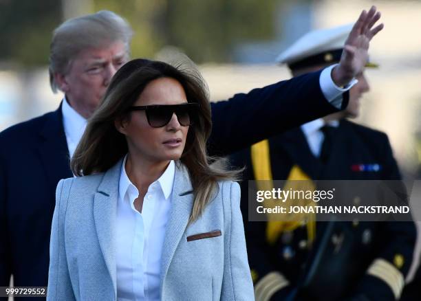 President Donald Trump and US First Lady Melania Trump walk towards the presidential car upon arrival at Helsinki-Vantaa Airport in Helsinki, on July...