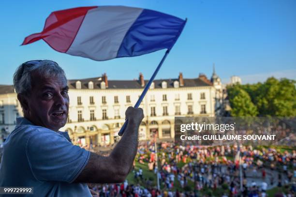 Tours' mayor Christophe Boucher waves a French flag as he celebrates in Tours on July 15 after France won the Russia 2018 World Cup final football...