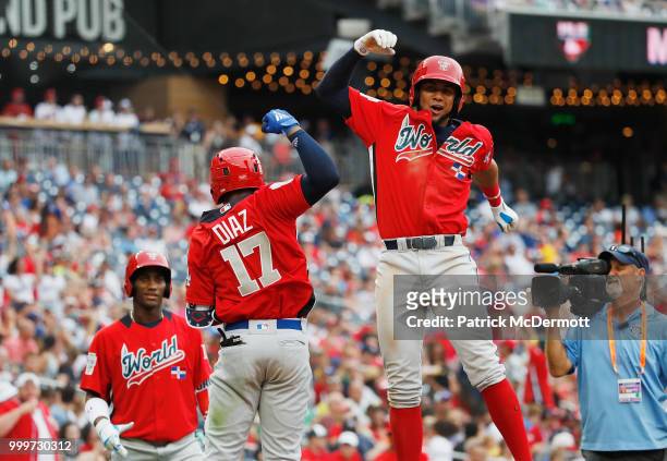Yusniel Diaz of the Los Angeles Dodgers and the World Team celebrates after hitting a two-run home run with teammate Seuly Matias of the Kansas City...