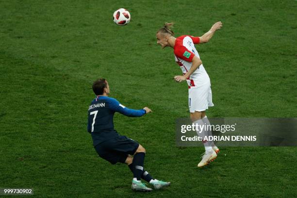 Croatia's defender Domagoj Vida heads the ball as he vies for it with France's forward Antoine Griezmann during the Russia 2018 World Cup final...
