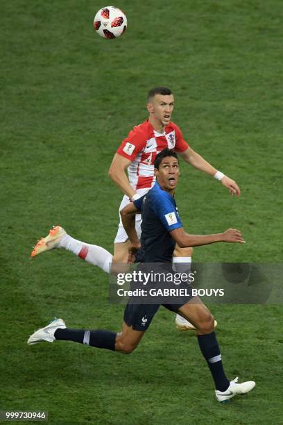 France's defender Raphael Varane vies for the ball with Croatia's forward Ivan Perisic during the Russia 2018 World Cup final football match between...