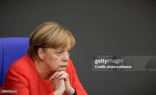German chancellor Angela Merkel watches a debate during the last official meeting day of the German parliament before the elections 2017, in Berlin,...