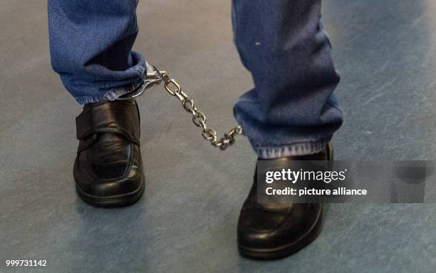 The defendant Hussein K. Is brought back into the court room wearing shackles after a break during his trial in Freiburg, Germany, 5 September 2017....