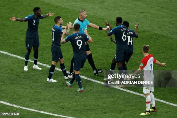 France's players talk to Argentinian referee Nestor Pitana during the Russia 2018 World Cup final football match between France and Croatia at the...