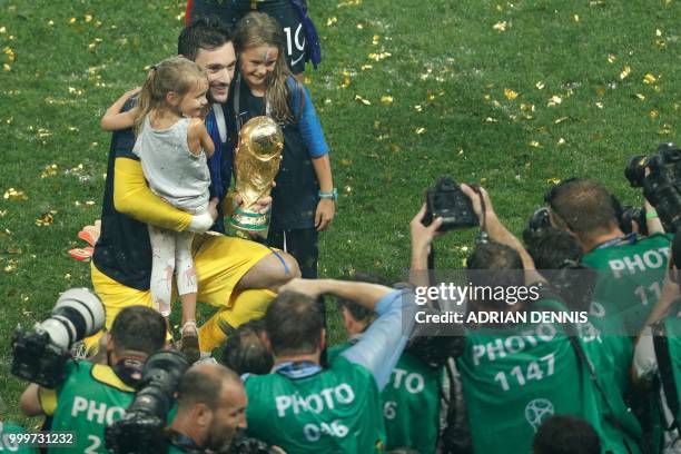 France's goalkeeper Hugo Lloris poses with the World Cup trophy after winning the Russia 2018 World Cup final football match between France and...