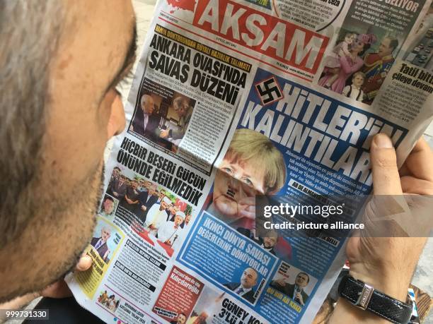 Man reads the Turkish newspaper "Aksam" in Istanbul, Germany, 5 September 2017. The paper appeared with the Swastika on its front page and the...