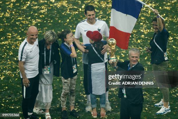 France's coach Didier Deschamps celebrates with the World Cup trophy at the end of the Russia 2018 World Cup final football match between France and...