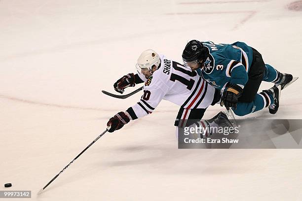 Patrick Sharp of the Chicago Blackhawks dives for the puck in front of Douglas Murray of the San Jose Sharks in the first period of Game Two of the...
