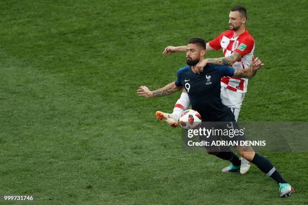 France's forward Olivier Giroud fights for the ball with Croatia's midfielder Marcelo Brozovic during the Russia 2018 World Cup final football match...