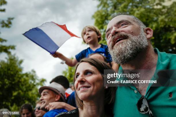 Supporters celebrate France's victory in the Russia 2018 World Cup final football match between France and Croatia, in Lausanne, western Switzerland,...