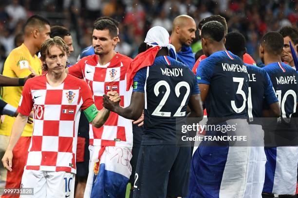 Croatia's midfielder Luka Modric greets France's defender Benjamin Mendy during the trophy ceremony at the end of the Russia 2018 World Cup final...