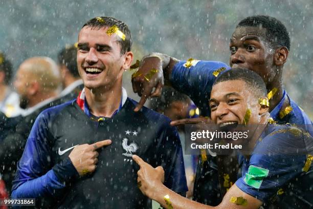 Antoine Griezmann, Paul Pogba and Kylian Mbappe of France celebrate victory folowing the 2018 FIFA World Cup Final between France and Croatia at...