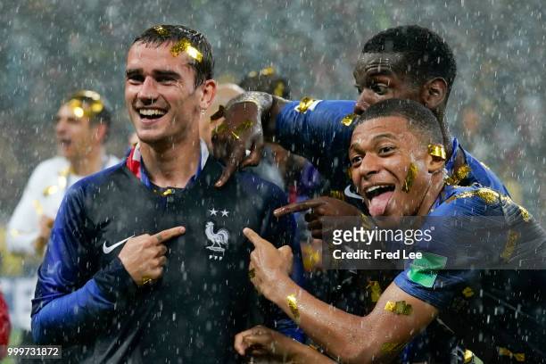 Antoine Griezmann, Paul Pogba and Kylian Mbappe of France celebrate victory folowing the 2018 FIFA World Cup Final between France and Croatia at...