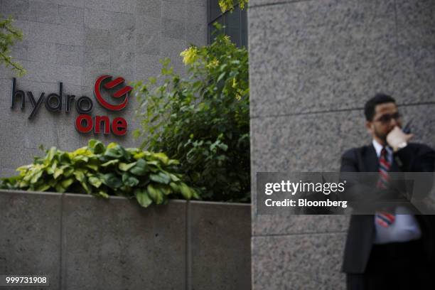 Security guard stands outside of the Hydro One Ltd. Headquarters in Toronto, Ontario, Canada, on Thursday, July 12, 2018. Hydro One is facing a...