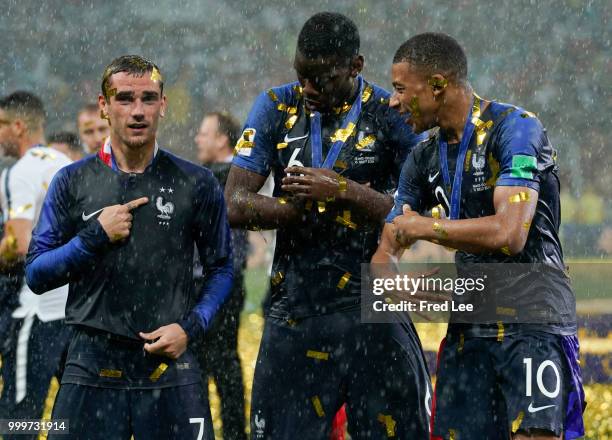 Antoine Griezmann, Paul Pogba and Kylian Mbappe of France celebrate victory folowing the 2018 FIFA World Cup Final between France and Croatia at...