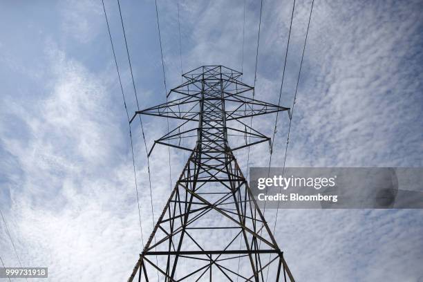 Power lines run through a Hydro One Ltd. Transmission tower in Toronto, Ontario, Canada, on Thursday, July 12, 2018. Hydro One is facing a long-term...