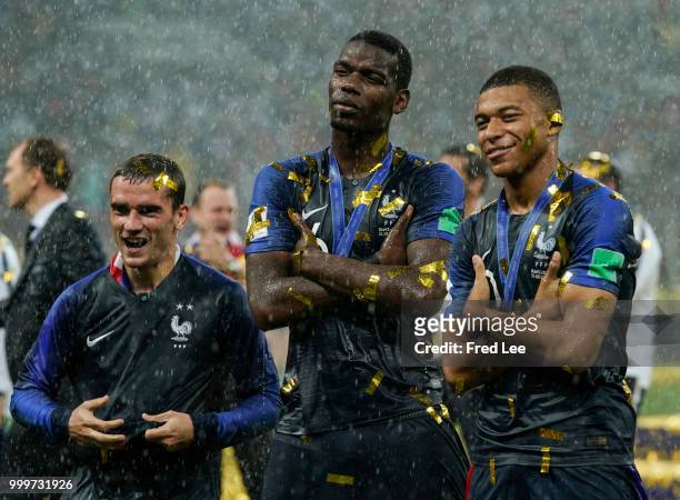 Antoine Griezmann, Paul Pogba and Kylian Mbappe of France celebrate victory folowing the 2018 FIFA World Cup Final between France and Croatia at...