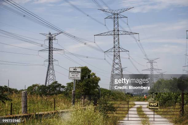 Power lines run through Hydro One Ltd. Transmission towers in Toronto, Ontario, Canada, on Thursday, July 12, 2018. Hydro One is facing a long-term...
