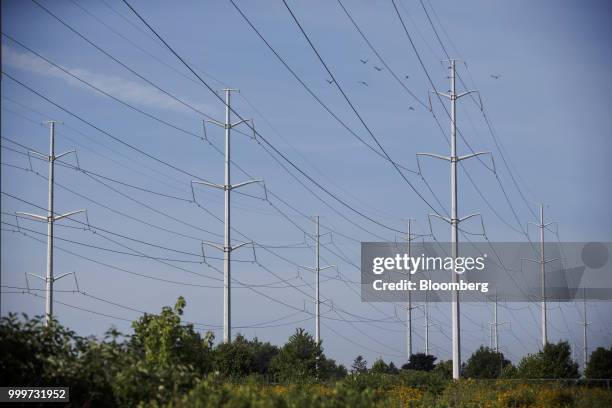 Power lines run through Hydro One Ltd. Transmission towers in Toronto, Ontario, Canada, on Thursday, July 12, 2018. Hydro One is facing a long-term...