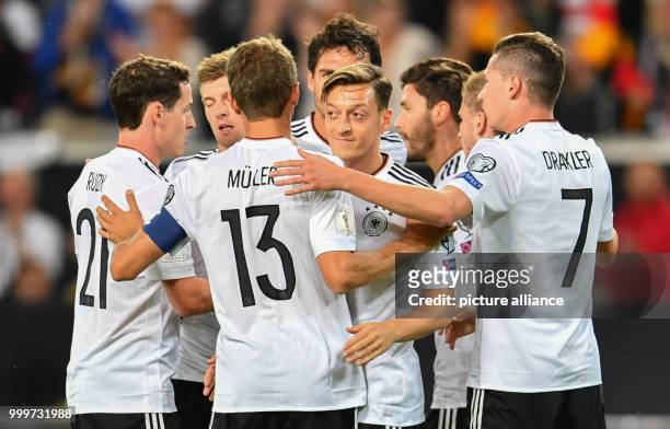 Germany's players cheer with the 1-0 scorer Mesut Oezil during the soccer World Cup qualification group stage match between Germany and Norway in the...