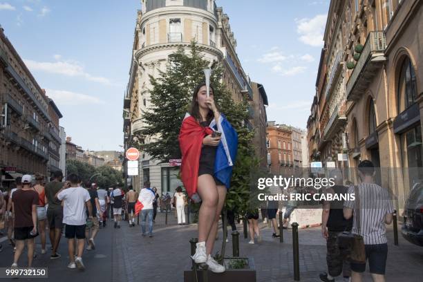 People celebrate France's victory in the Russia 2018 World Cup final football match between France and Croatia, on July 15, 2018 in Toulouse's city...