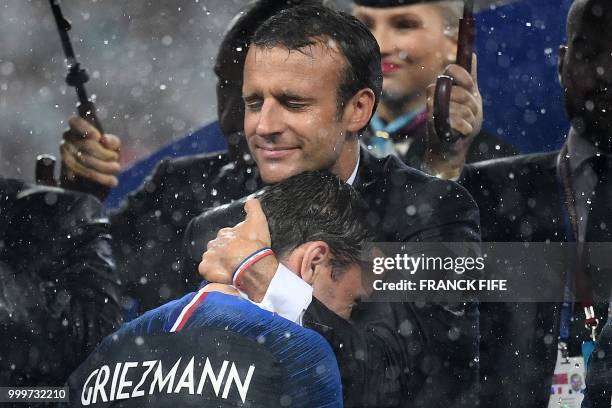 French President Emmanuel Macron congratulates France's forward Antoine Griezmann during the trophy ceremony after winning the Russia 2018 World Cup...