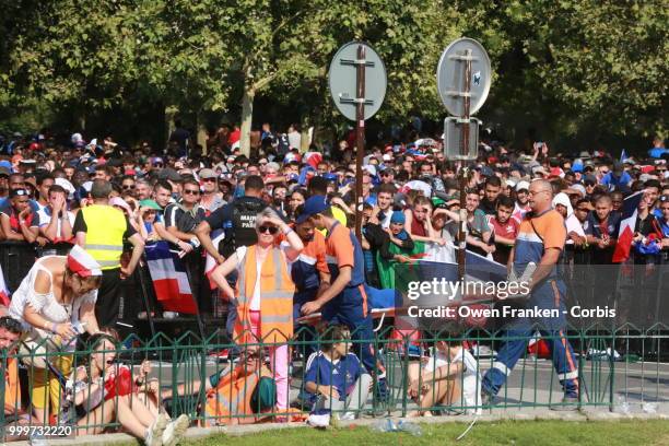 Woman is taken to medical care during during the World Cup final against Croatia, on July 15, 2018 in the Champs de Mars, near the Eiffel Tower...