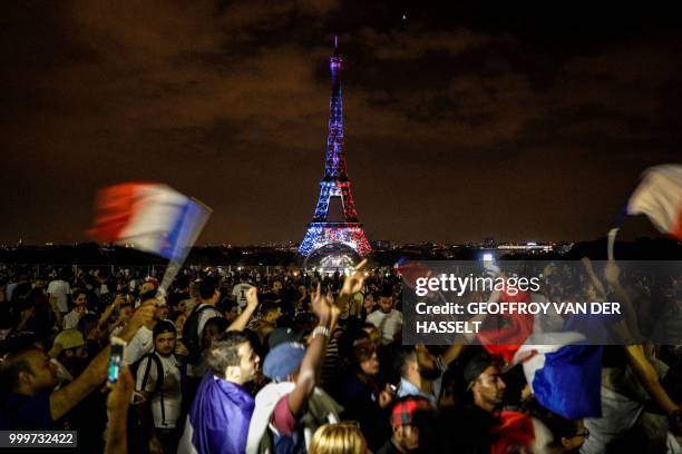 This picture taken from Trocadero on July 15, 2018 shows the Eiffel Tower illuminated in French national colors during celebrations after the Russia...