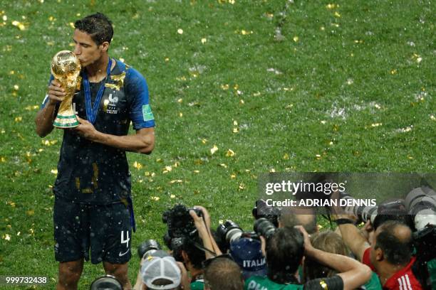 France's defender Raphael Varane kisses the trophy as he celebrates at the end of the Russia 2018 World Cup final football match between France and...