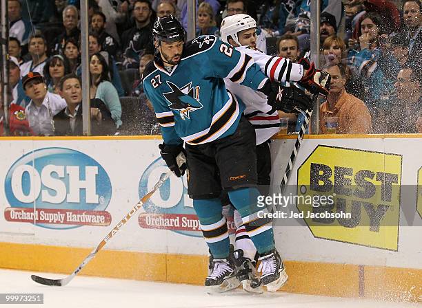 Manny Malhotra of the San Jose Sharks checks Niklas Hjalmarsson of the Chicago Blackhawks in the first period of Game Two of the Western Conference...
