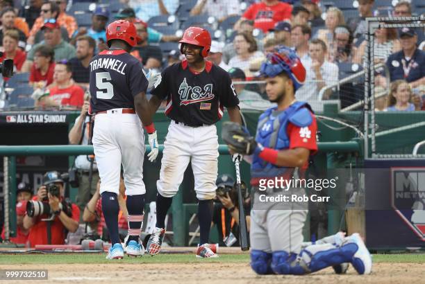 Taylor Trammell of the Cincinnati Reds and the U.S. Team celebrates solo home run with Ke'Bryan Hayes of the Pittsburgh Pirates and the U.S. Team in...