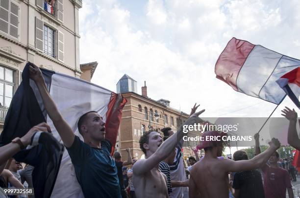 People celebrate France's victory in the Russia 2018 World Cup final football match between France and Croatia, on July 15, 2018 in Toulouse's city...