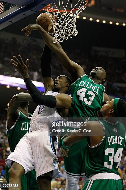 Dwight Howard of the Orlando Magic draws contact as he attempts a shot against Kendrick Perkins and Paul Pierce of the Boston Celtics in Game Two of...