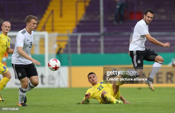 Germany's Lukas Klostermann and Levin Oeztunali and Kosovo's Florian Loshaj in action during the 2019 U21 EURO group 5 qualifying match between...