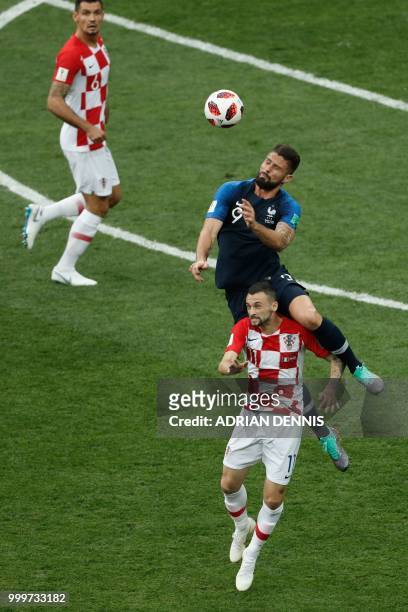 France's forward Olivier Giroud heads the ball as he vies for it with Croatia's midfielder Marcelo Brozovic during the Russia 2018 World Cup final...