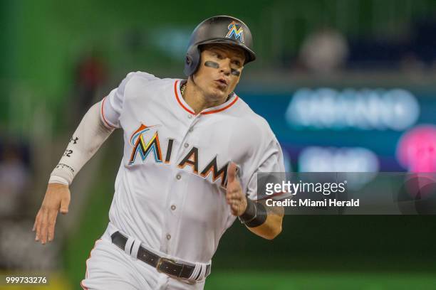 Miami Marlins left fielder Derek Dietrich reaches third base after a double by Miami Marlins right fielder Brian Anderson during the eight inning...