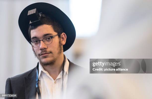 Devoted Jew with a traditional hat watches other people praying at the Westend Synagogue in Frankfurt/Main, Germany, 5 September 2017. Religious jews...