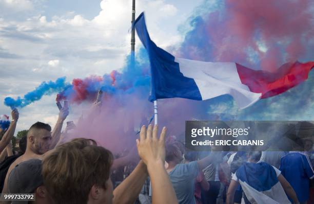 People celebrate France's victory in the Russia 2018 World Cup final football match between France and Croatia, on July 15, 2018 in Toulouse's city...