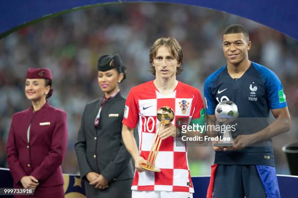 Luka Modric of Croatia poses with the FIFA Golden Ball for player of the tournament and Kylian Mbappe of France the silver ball for best young player...