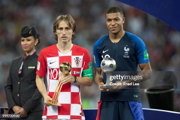 Luka Modric of Croatia poses with the FIFA Golden Ball for player of the tournament and Kylian Mbappe of France the silver ball for best young player...